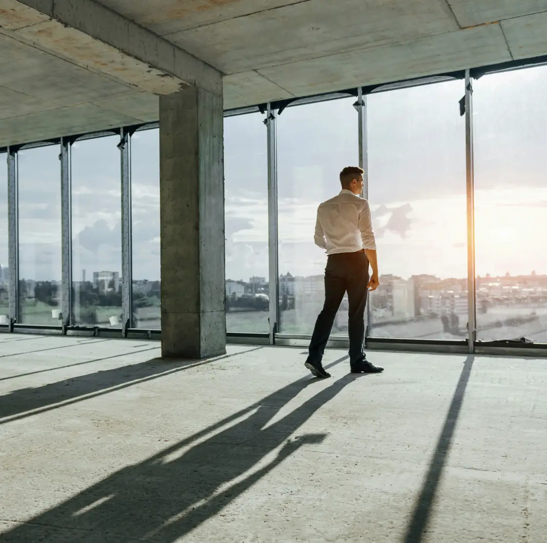 Man looking outside of window at opportunity